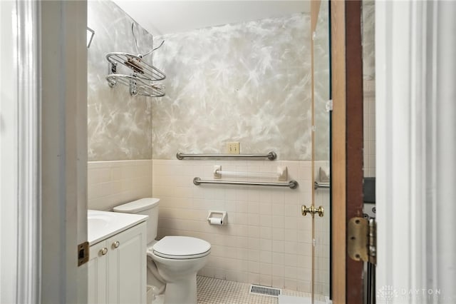 328 Shadywood Dr, Clayton, OH 45415 - bathroom featuring vanity, tile walls, tile patterned floors, and wainscoting