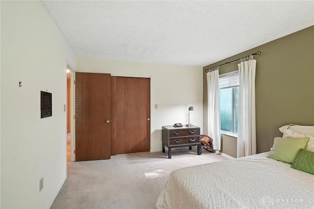 328 Shadywood Dr, Clayton, OH 45415 - bedroom with light colored carpet, a closet, and a textured ceiling