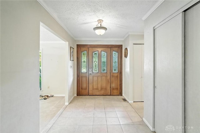 328 Shadywood Dr, Clayton, OH 45415 - foyer entrance featuring plenty of natural light, light tile patterned floors, a textured ceiling, and ornamental molding