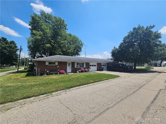 103 N Taylor St Unit 101, Farmersville, OH 45325 - view of front facade featuring an attached garage, a front lawn, driveway, and brick siding