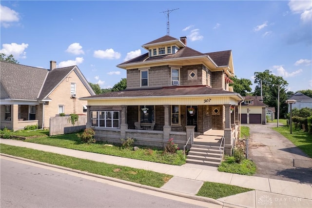 307 E Cherry St, New Paris, OH 45347 - traditional style home with covered porch, a chimney, roof with shingles, and driveway