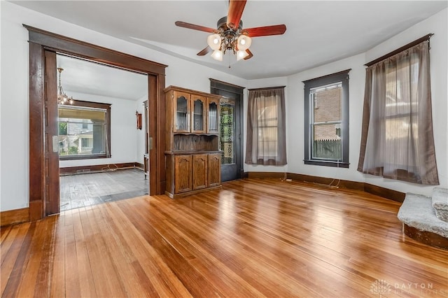 307 E Cherry St, New Paris, OH 45347 - unfurnished living room featuring a ceiling fan and hardwood / wood-style flooring