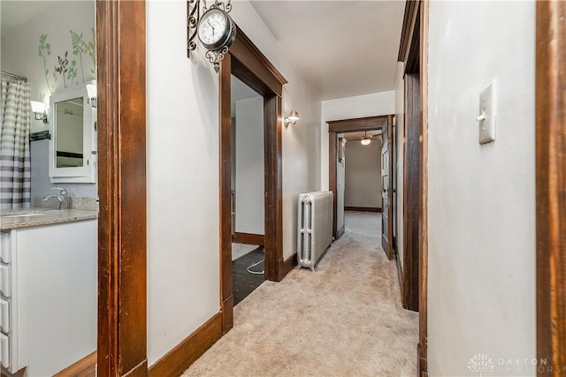 307 E Cherry St, New Paris, OH 45347 - hallway featuring radiator and light carpet
