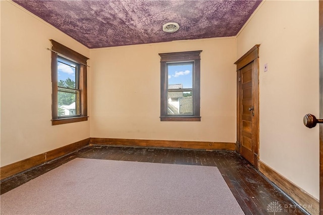 307 E Cherry St, New Paris, OH 45347 - empty room featuring ornamental molding, dark carpet, and dark wood-style floors