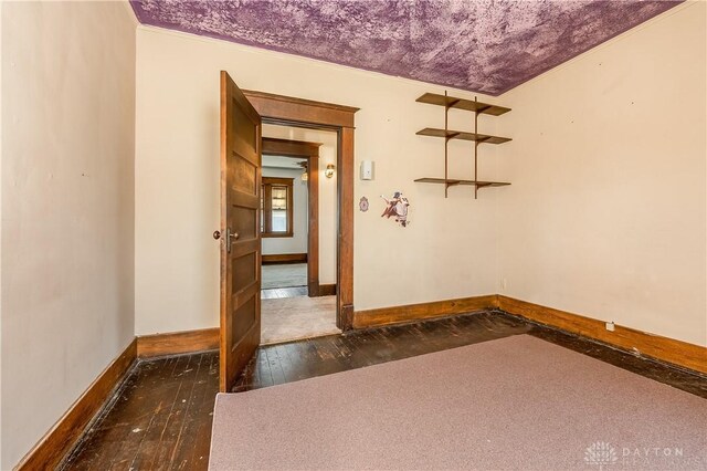 307 E Cherry St, New Paris, OH 45347 - spare room featuring baseboards and dark wood-style floors