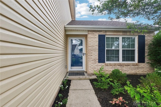 4307 Dobbin Cir, Dayton, OH 45424 - view of exterior entry with brick siding and a shingled roof