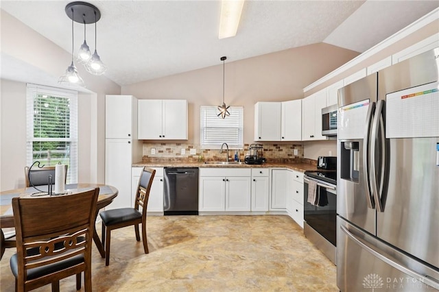 4307 Dobbin Cir, Dayton, OH 45424 - kitchen with appliances with stainless steel finishes, lofted ceiling, white cabinets, backsplash, and pendant lighting