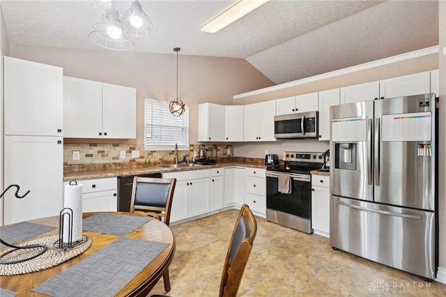 4307 Dobbin Cir, Dayton, OH 45424 - kitchen with stainless steel appliances, vaulted ceiling, white cabinets, backsplash, and pendant lighting