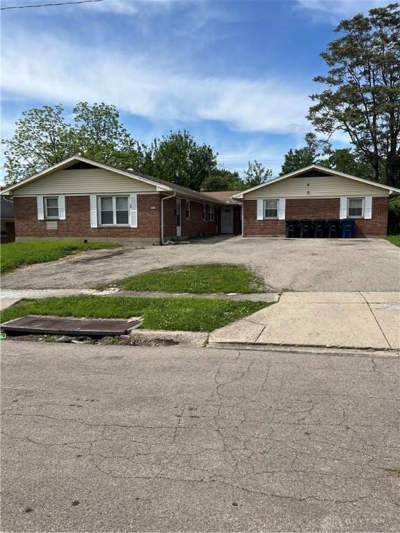 4051 Crest Dr, Dayton, OH 45416 - ranch-style house featuring driveway, brick siding, and an attached garage