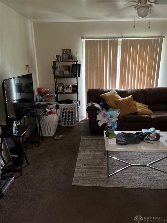 4051 Crest Dr, Dayton, OH 45416 - living room featuring dark colored carpet and ceiling fan