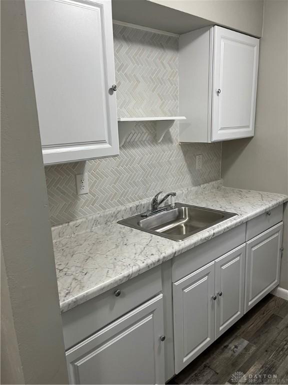 4051 Crest Dr, Dayton, OH 45416 - kitchen with dark wood-type flooring, decorative backsplash, and white cabinets