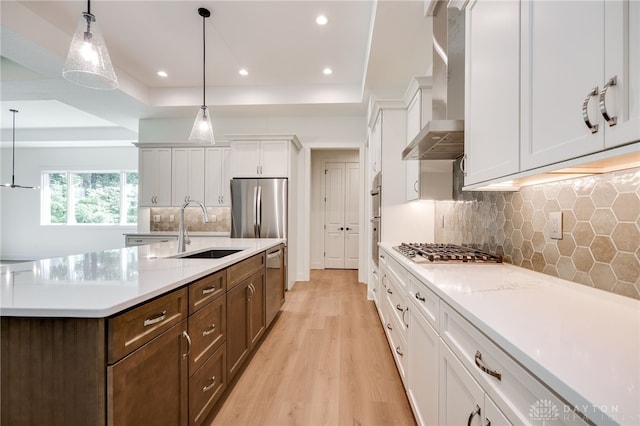 9508 Magnolia Ct, Washington Twp, OH 45458 - kitchen with appliances with stainless steel finishes, a raised ceiling, light countertops, light wood finished floors, and white cabinetry