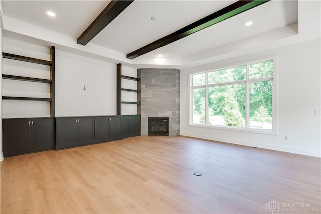 9508 Magnolia Ct, Washington Twp, OH 45458 - unfurnished living room featuring beamed ceiling, light wood-style floors, a tiled fireplace, and recessed lighting