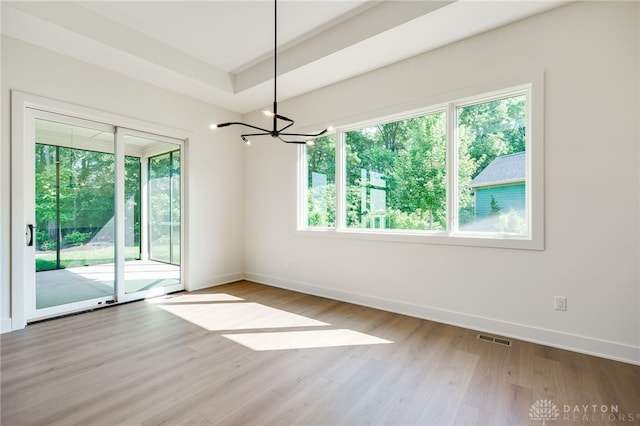 9508 Magnolia Ct, Washington Twp, OH 45458 - spare room featuring healthy amount of natural light, a chandelier, and light wood-style flooring