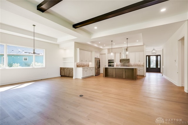 9508 Magnolia Ct, Washington Twp, OH 45458 - unfurnished living room with a tray ceiling, recessed lighting, light wood-type flooring, and beam ceiling