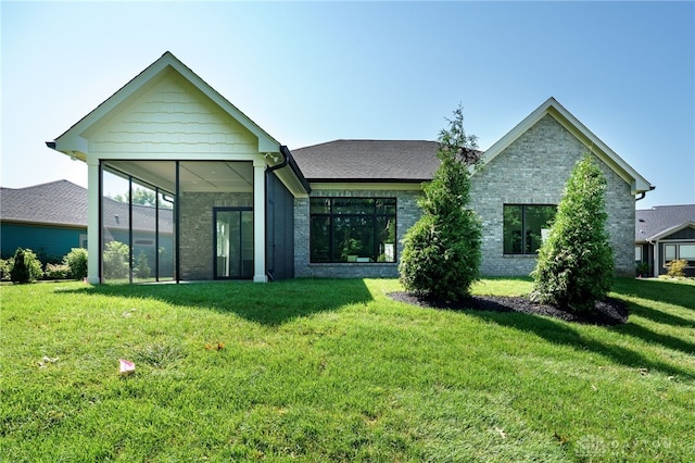 9508 Magnolia Ct, Washington Twp, OH 45458 - back of house with a lawn, a sunroom, and brick siding
