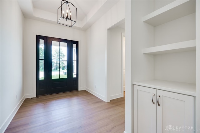 9508 Magnolia Ct, Washington Twp, OH 45458 - entrance foyer with light wood-style flooring, a chandelier, and a raised ceiling
