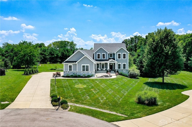 7949 Bending Willow Ct, Clearcreek Twp, OH 45068 - view of front of house with stone siding, a porch, driveway, and a front lawn