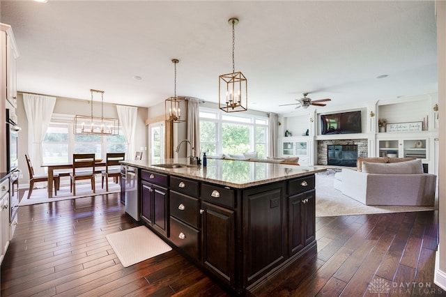 7949 Bending Willow Ct, Clearcreek Twp, OH 45068 - kitchen with a fireplace, stainless steel appliances, dark wood-style floors, and plenty of natural light
