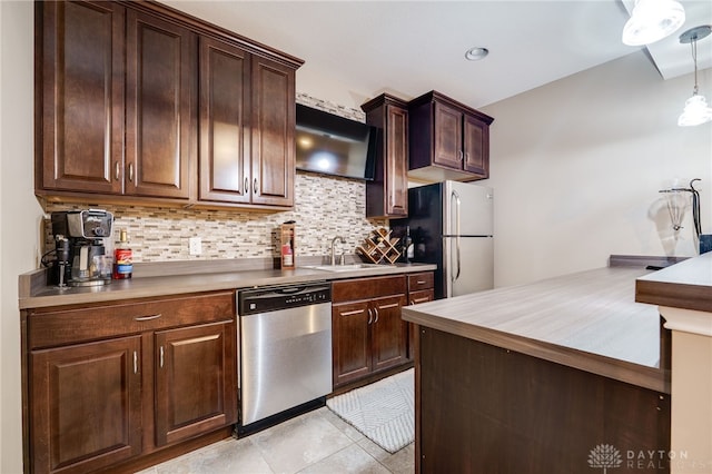 7949 Bending Willow Ct, Clearcreek Twp, OH 45068 - kitchen featuring stainless steel appliances, backsplash, dark brown cabinets, light tile patterned flooring, and light countertops
