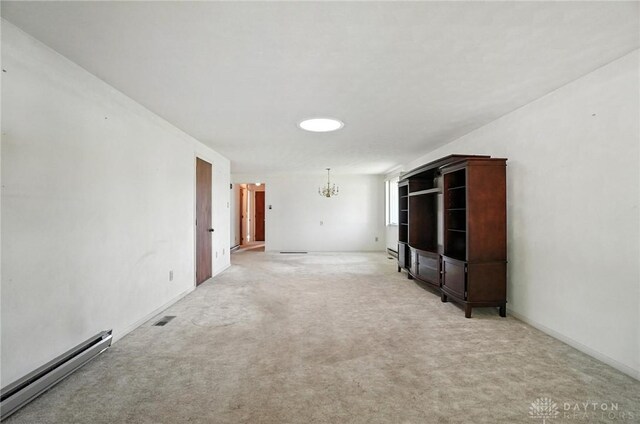 634 S Main, West Milton, OH 45383 - unfurnished living room with baseboard heating, a chandelier, and light colored carpet
