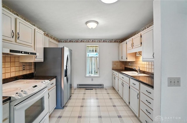 634 S Main, West Milton, OH 45383 - kitchen with white electric stove, a baseboard heating unit, extractor fan, dark countertops, and light flooring