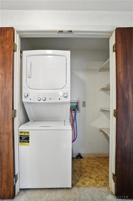 634 S Main, West Milton, OH 45383 - washroom featuring stacked washer / dryer and baseboards