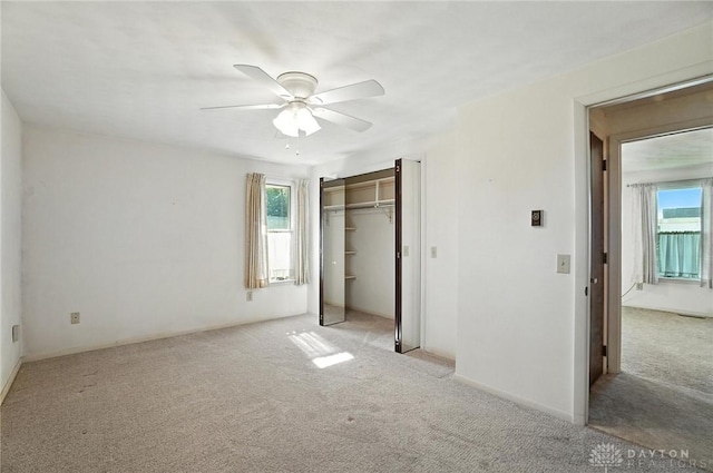 634 S Main, West Milton, OH 45383 - unfurnished bedroom featuring carpet flooring, multiple windows, a ceiling fan, and a closet