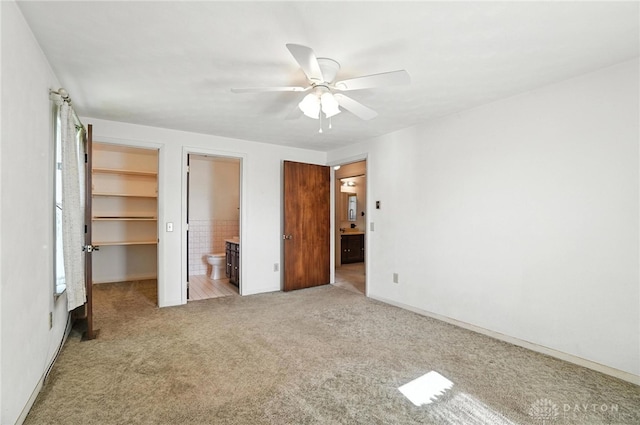 634 S Main, West Milton, OH 45383 - unfurnished bedroom featuring carpet, a spacious closet, ensuite bathroom, a ceiling fan, and a closet
