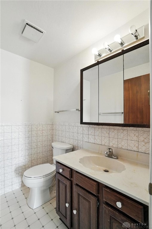 634 S Main, West Milton, OH 45383 - half bath with tile walls, vanity, a wainscoted wall, and tile patterned floors