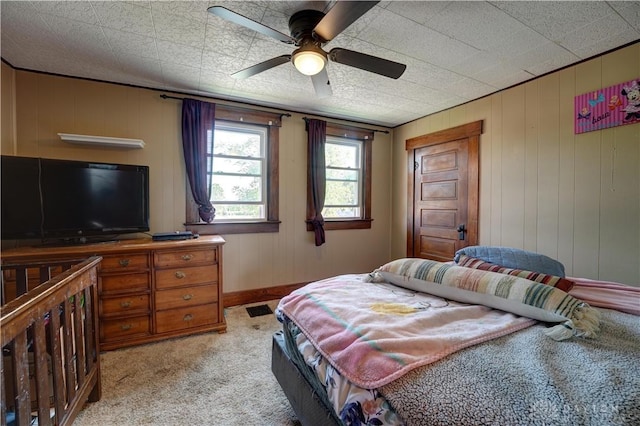 513 S High St, Arcanum, OH 45304 - bedroom featuring light colored carpet, a ceiling fan, and wood walls