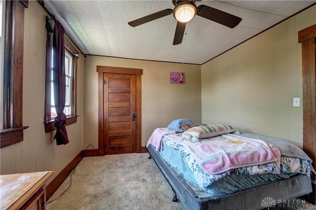 513 S High St, Arcanum, OH 45304 - bedroom with light colored carpet, wood walls, and a ceiling fan