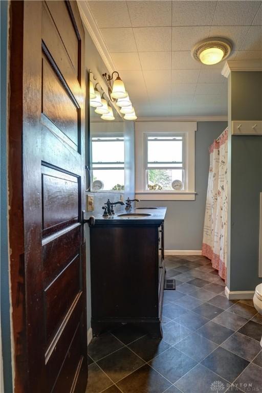513 S High St, Arcanum, OH 45304 - bathroom with ornamental molding, vanity, tile patterned flooring, and a shower with shower curtain