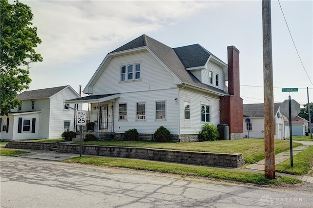 513 S High St, Arcanum, OH 45304 - view of front of home with a chimney and a front lawn