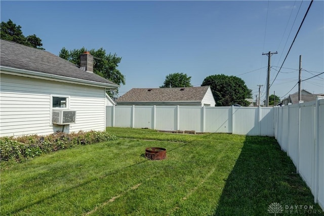513 S High St, Arcanum, OH 45304 - fenced backyard featuring an outdoor fire pit and cooling unit
