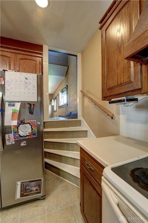 513 S High St, Arcanum, OH 45304 - kitchen with freestanding refrigerator, brown cabinets, and light countertops
