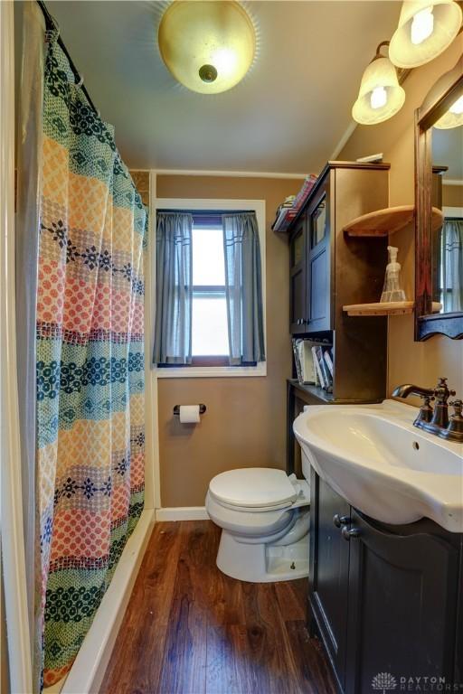 513 S High St, Arcanum, OH 45304 - bathroom with vanity, wood finished floors, and a shower with curtain