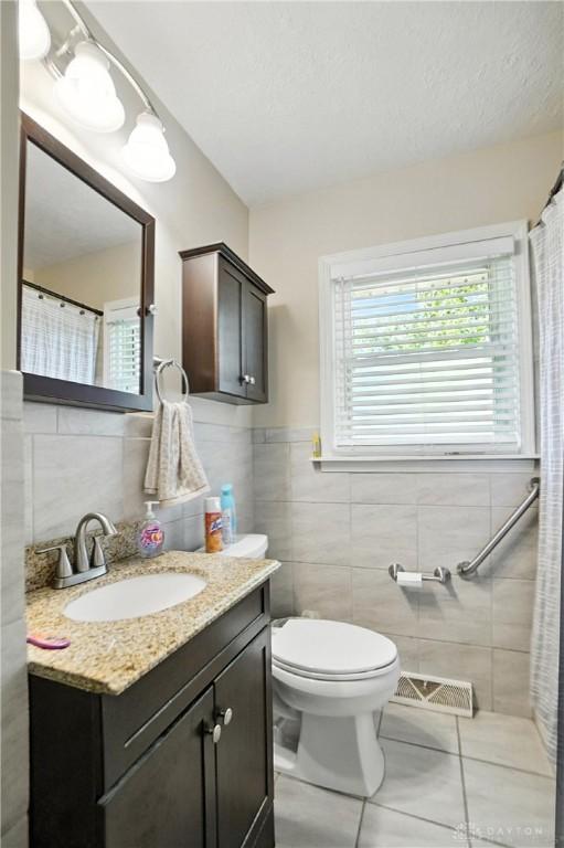 4513 Hannah Dr, Middletown, OH 45044 - bathroom with tile walls, vanity, and tile patterned floors