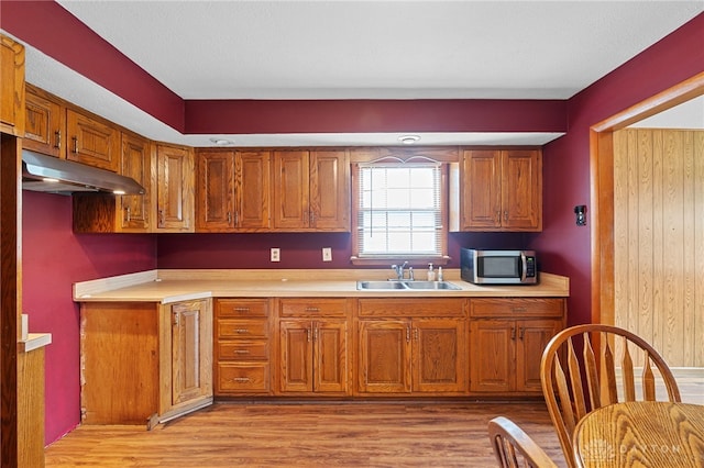 250 Pat Ln, Fairborn, OH 45324 - kitchen with stainless steel microwave, brown cabinets, under cabinet range hood, and light countertops