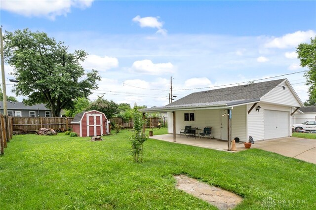 250 Pat Ln, Fairborn, OH 45324 - fenced backyard featuring a shed, concrete driveway, and a patio area