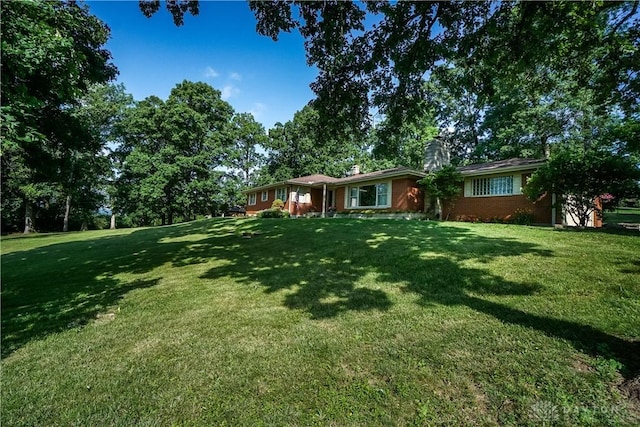 5975 Oakridge Dr, Hamilton, OH 45011 - view of front of property with a front yard, brick siding, and a chimney