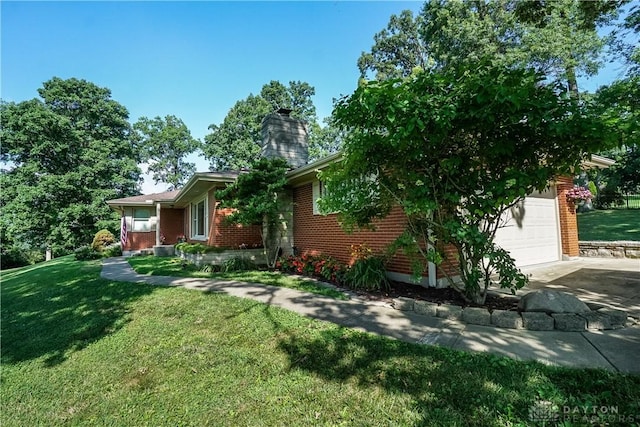 5975 Oakridge Dr, Hamilton, OH 45011 - view of front of house featuring brick siding, a front lawn, a garage, and a chimney