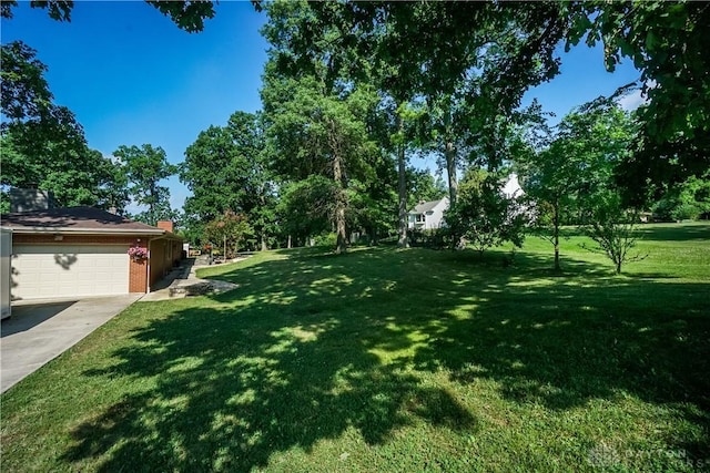 5975 Oakridge Dr, Hamilton, OH 45011 - view of grassy yard with concrete driveway and an attached garage