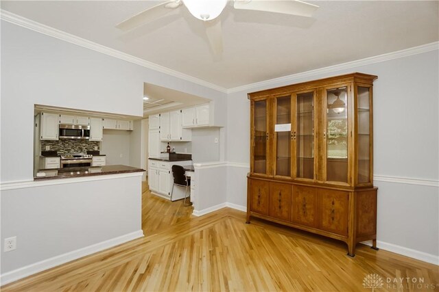5975 Oakridge Dr, Hamilton, OH 45011 - unfurnished dining area with light wood-style flooring, crown molding, and ceiling fan