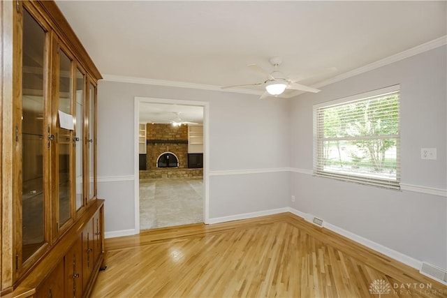 5975 Oakridge Dr, Hamilton, OH 45011 - unfurnished room with light wood-type flooring, ceiling fan, ornamental molding, and a large fireplace