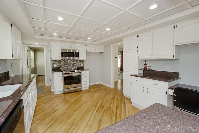 5975 Oakridge Dr, Hamilton, OH 45011 - kitchen featuring stainless steel appliances, light wood finished floors, recessed lighting, white cabinets, and tasteful backsplash
