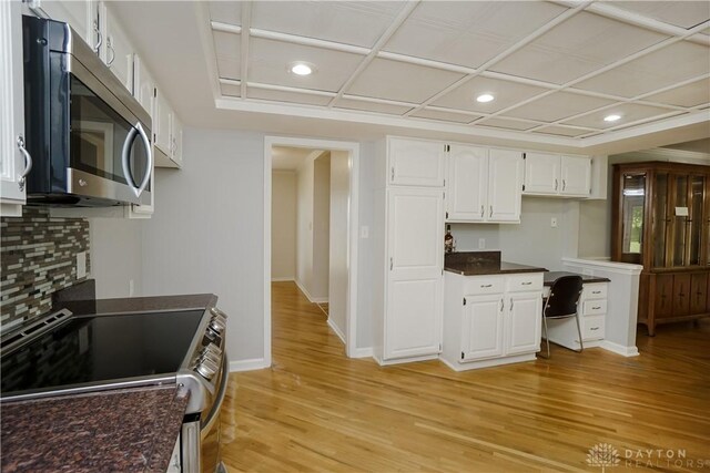 5975 Oakridge Dr, Hamilton, OH 45011 - kitchen featuring appliances with stainless steel finishes, dark countertops, white cabinetry, light wood-type flooring, and recessed lighting