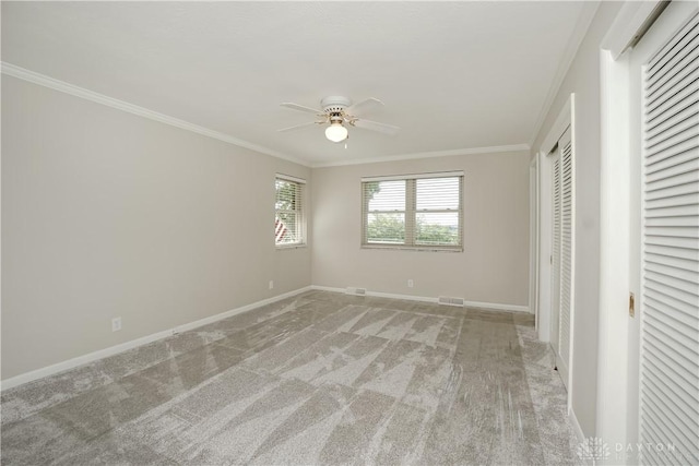 5975 Oakridge Dr, Hamilton, OH 45011 - unfurnished bedroom with crown molding, light colored carpet, ceiling fan, and a closet
