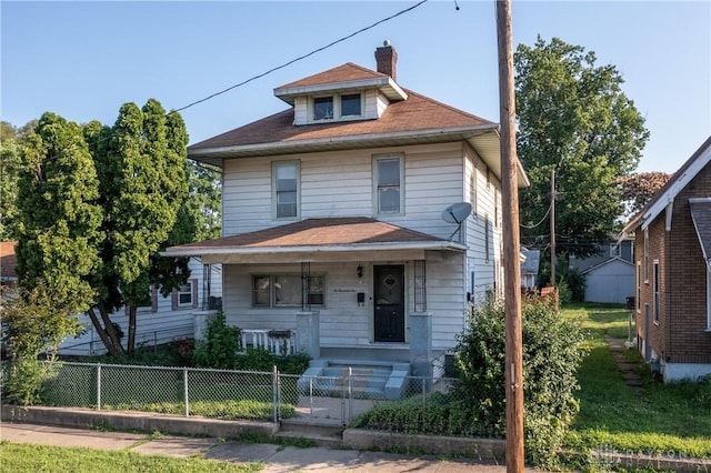 2005 Queen Ave, Middletown, OH 45044 - american foursquare style home with covered porch, a fenced front yard, a chimney, and a gate