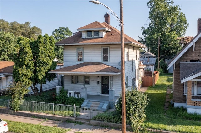 2005 Queen Ave, Middletown, OH 45044 - traditional style home featuring a porch, a chimney, and a fenced front yard